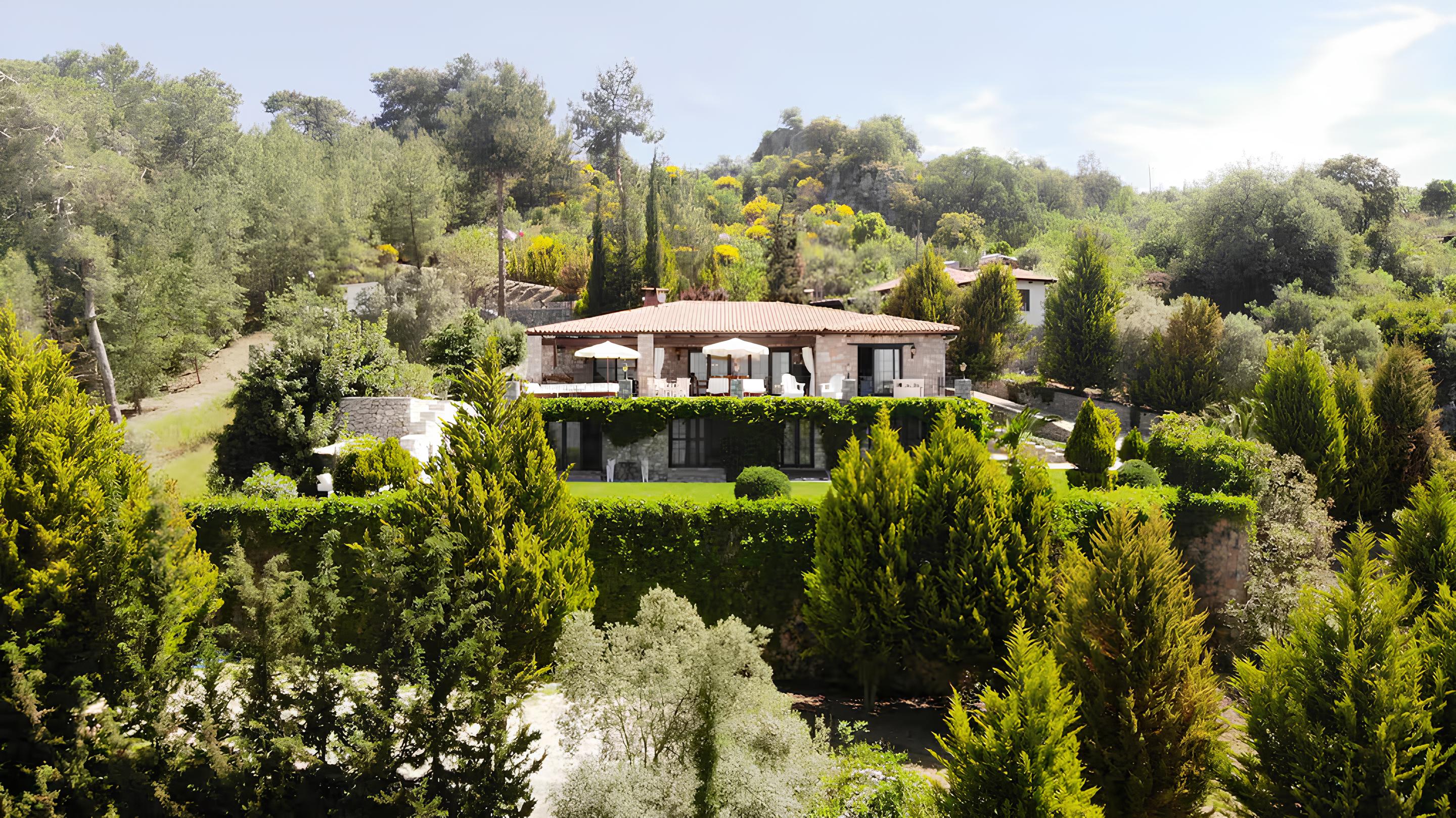 Villa interior with rustic chairs and stone walls